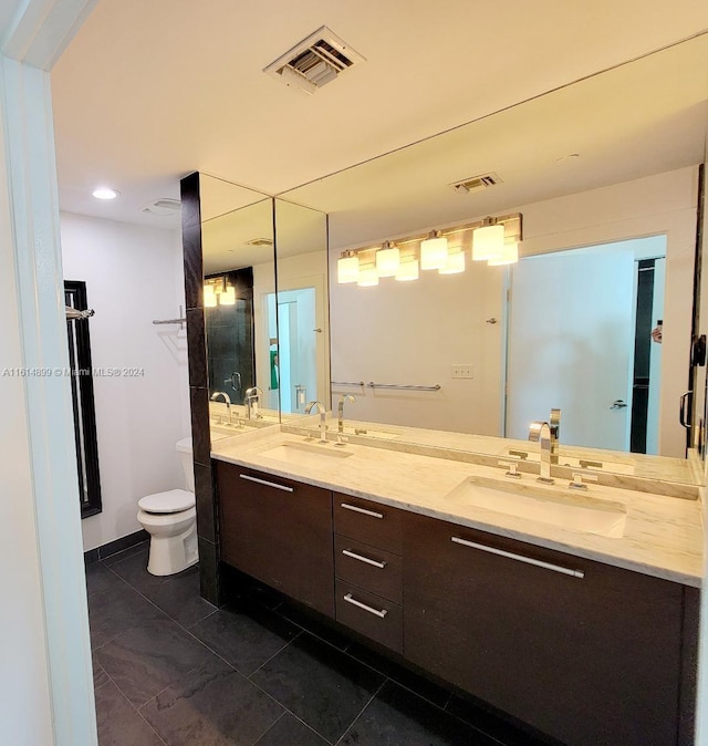 bathroom featuring tile patterned floors, vanity, and toilet