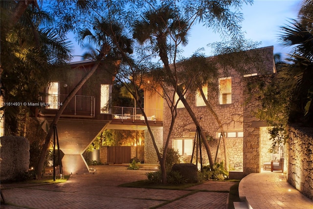 view of front of property featuring a carport and a balcony