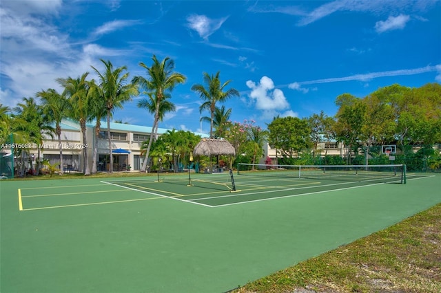 view of tennis court featuring basketball hoop