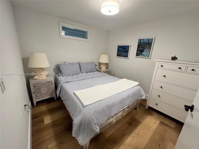 bedroom featuring beamed ceiling, ceiling fan, and light hardwood / wood-style flooring