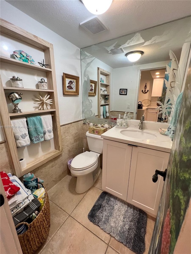 bathroom featuring tile patterned floors, vanity, and a textured ceiling