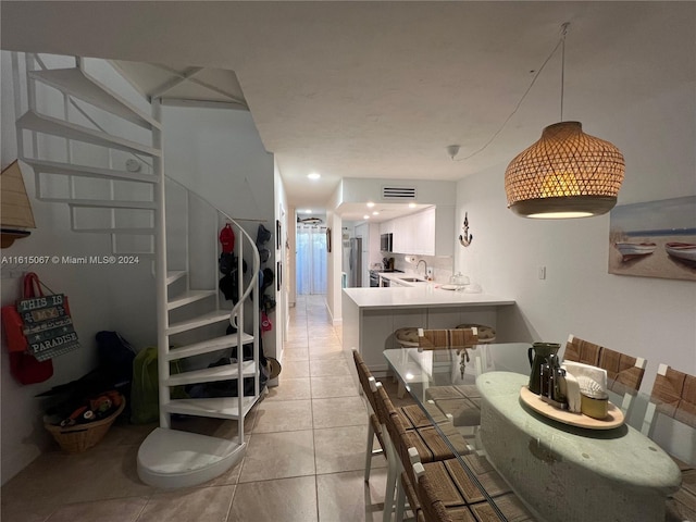 dining area featuring light tile patterned floors and beverage cooler