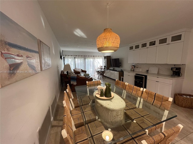 kitchen with kitchen peninsula, light tile patterned floors, a breakfast bar, and sink