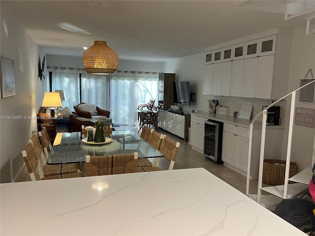 kitchen featuring white cabinetry, sink, and light tile patterned floors