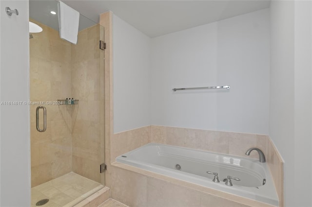 bathroom with shower with separate bathtub