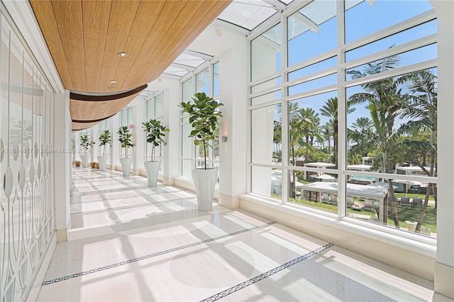 unfurnished sunroom with wood ceiling