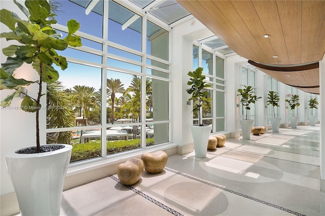 unfurnished sunroom with wooden ceiling