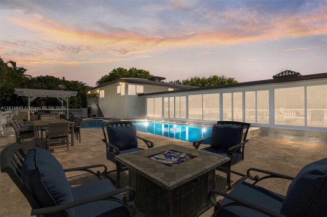 view of swimming pool with outdoor lounge area, an in ground hot tub, a patio area, and a pergola