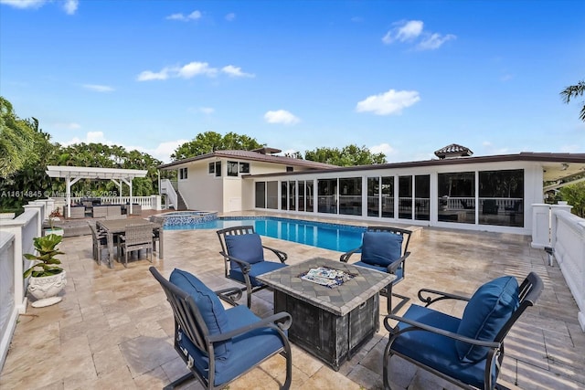 view of swimming pool featuring a pergola, a patio area, an in ground hot tub, and a fire pit