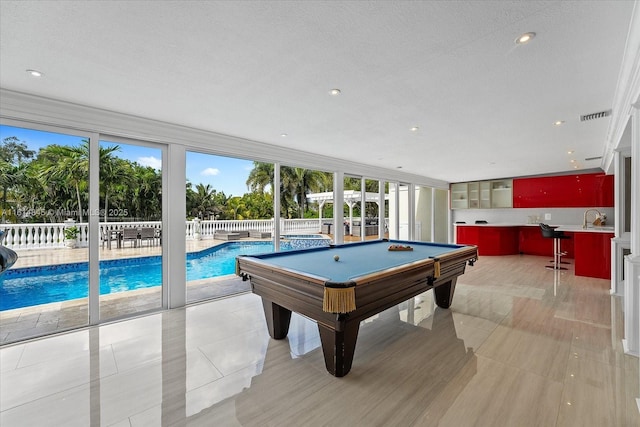 playroom featuring sink, pool table, and a textured ceiling