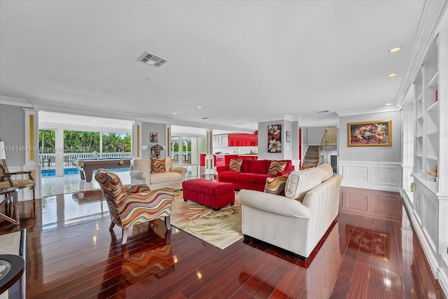 living room featuring dark hardwood / wood-style floors and crown molding