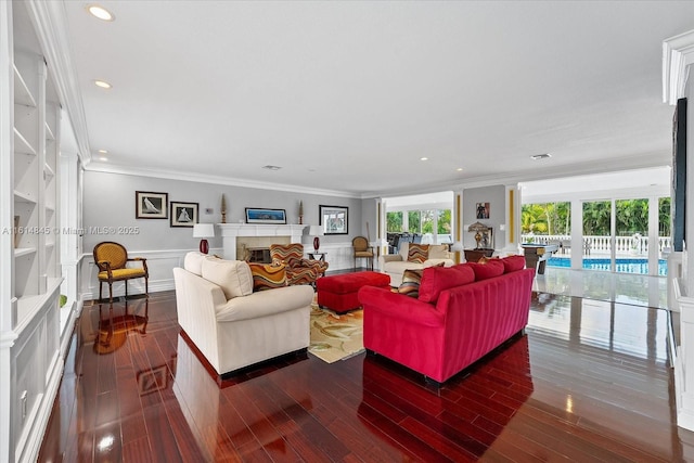 living room with built in features, dark hardwood / wood-style flooring, and crown molding