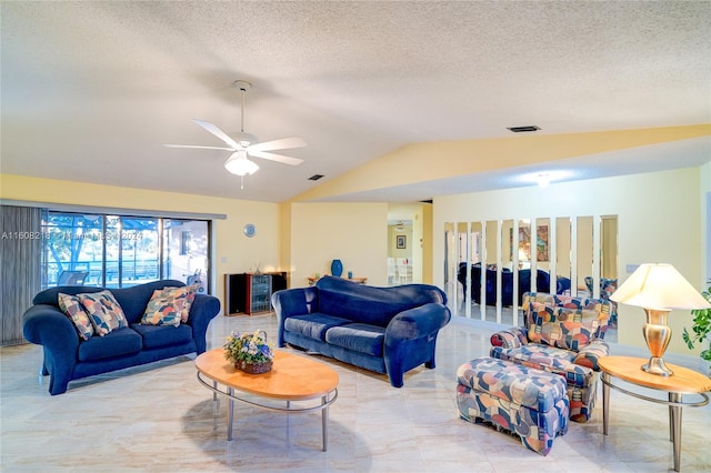 tiled living room featuring ceiling fan, a textured ceiling, and lofted ceiling