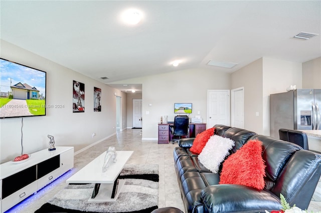 living room with light tile patterned floors and lofted ceiling