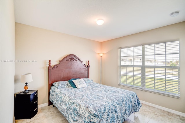 bedroom with light tile patterned floors