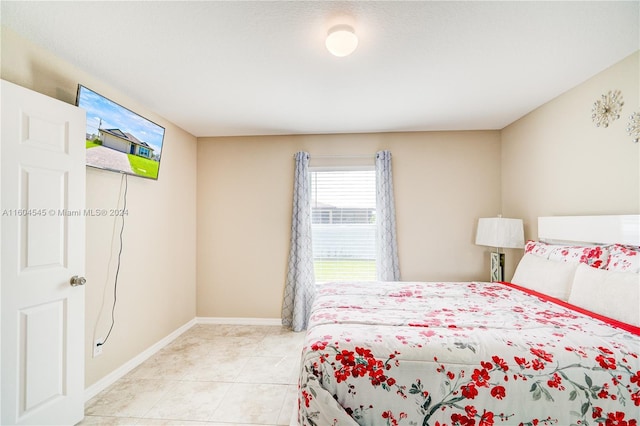 bedroom featuring light tile patterned flooring