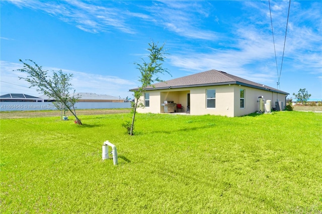 exterior space with a water view and a yard