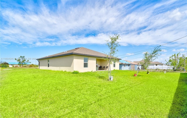 back of house featuring a yard