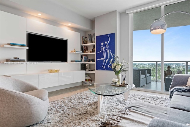 living room with floor to ceiling windows and hardwood / wood-style flooring