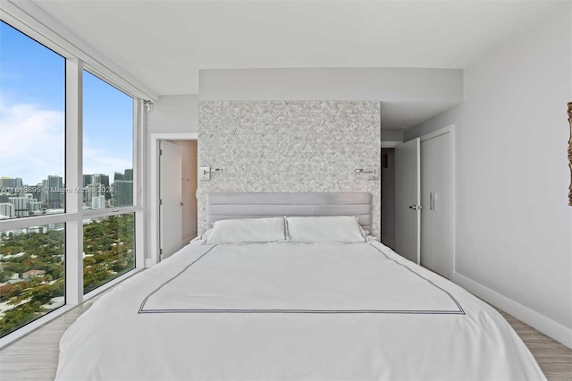 bedroom featuring multiple windows and light hardwood / wood-style floors