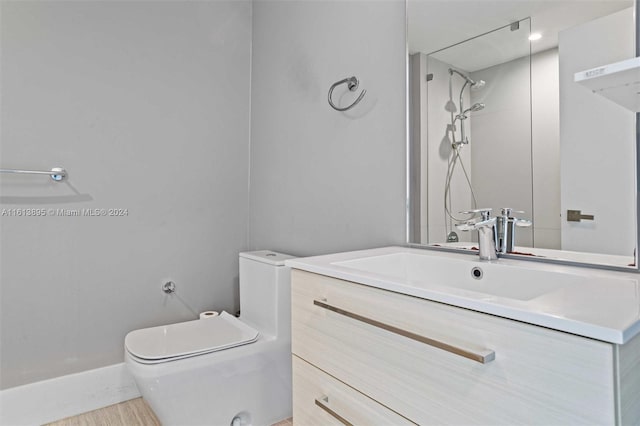 bathroom featuring vanity, toilet, and a shower