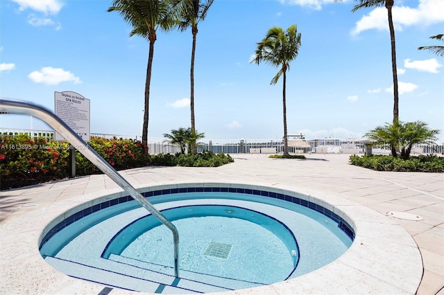 view of pool with a hot tub