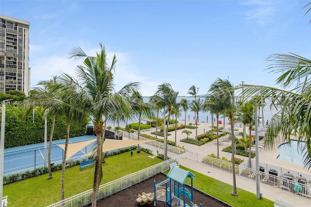 view of community featuring a playground and a water view