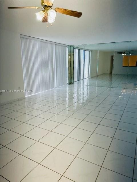 empty room featuring light tile patterned floors and ceiling fan