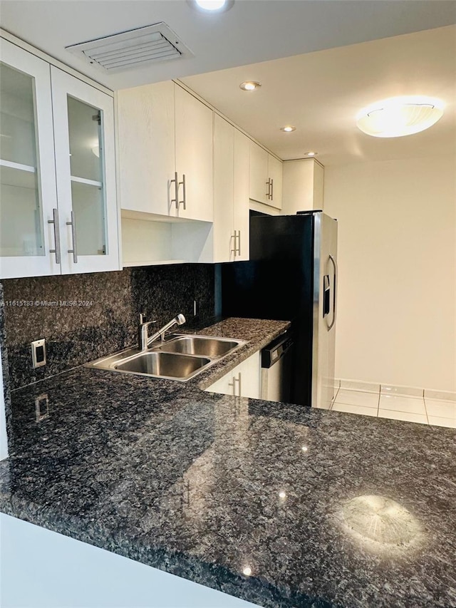 kitchen with dishwasher, sink, tasteful backsplash, kitchen peninsula, and white cabinets