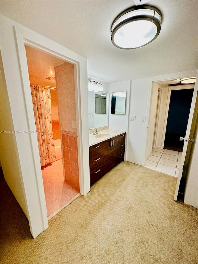 bathroom with a shower with shower curtain, vanity, and tile patterned floors