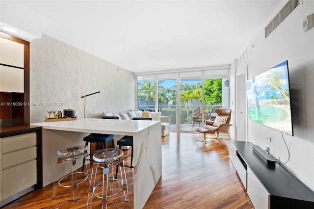 dining space featuring floor to ceiling windows and wood-type flooring