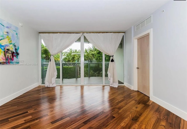 empty room with dark wood-type flooring