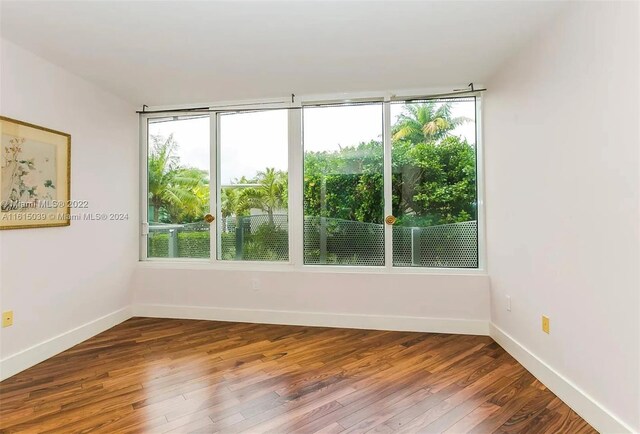 empty room with hardwood / wood-style flooring