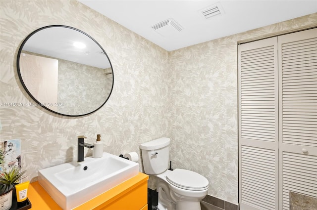 bathroom with toilet and vanity