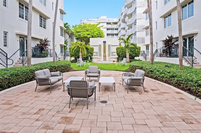 view of patio with an outdoor hangout area and a balcony