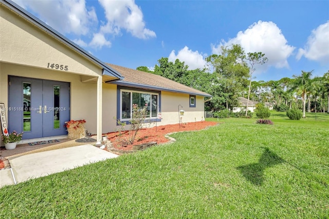 ranch-style home with a storage shed and a front lawn