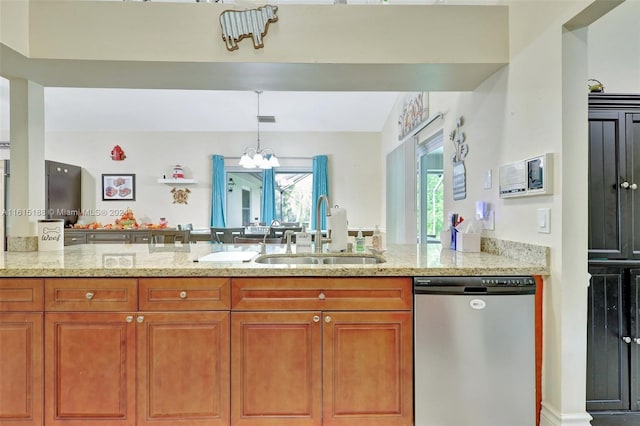 kitchen with light stone counters, hanging light fixtures, sink, kitchen peninsula, and dishwasher