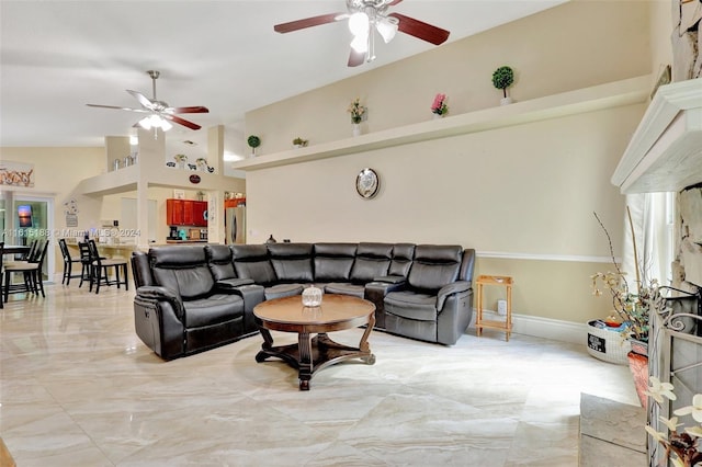 living room featuring ceiling fan and high vaulted ceiling