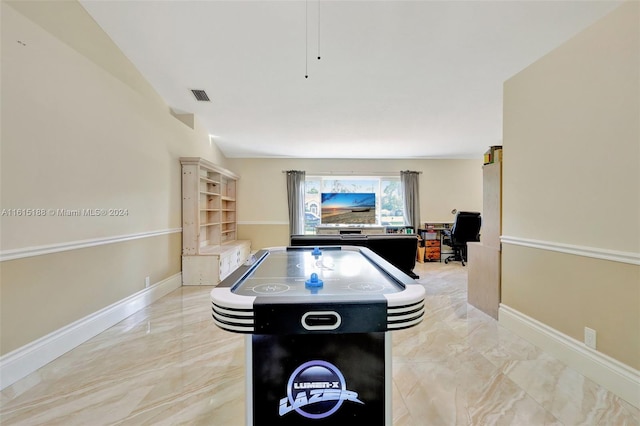 recreation room featuring vaulted ceiling