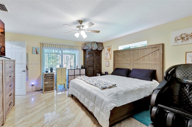 bedroom with ceiling fan, a textured ceiling, and beverage cooler