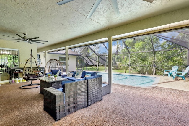 view of swimming pool with glass enclosure, outdoor lounge area, ceiling fan, and a patio