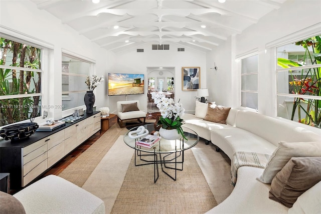 living room with lofted ceiling with beams and hardwood / wood-style flooring