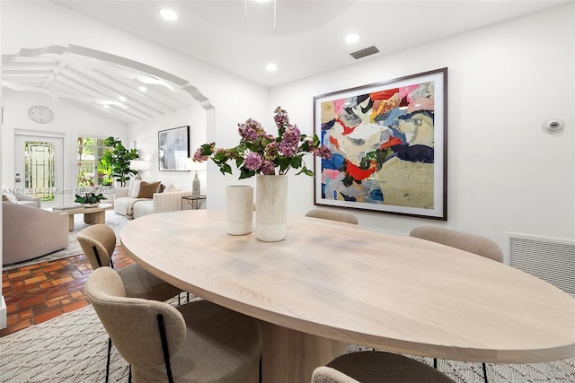 dining room featuring ceiling fan and lofted ceiling