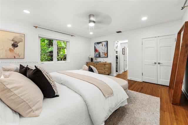 bedroom featuring ceiling fan, a closet, and hardwood / wood-style floors