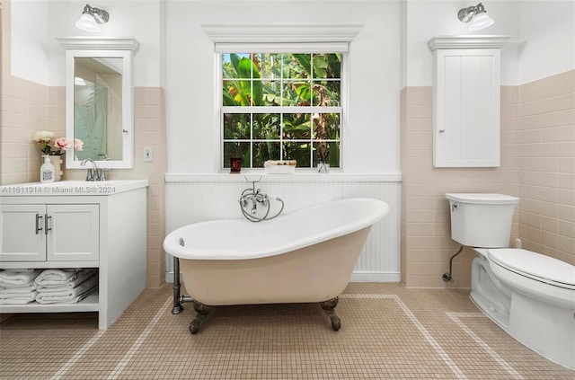 bathroom with a tub, tile patterned flooring, vanity, and toilet