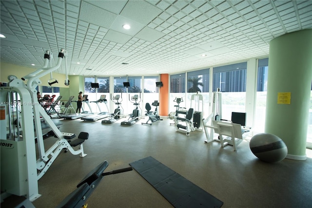 gym featuring floor to ceiling windows and a healthy amount of sunlight