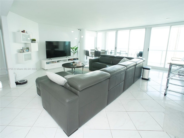 living room featuring light tile patterned flooring and floor to ceiling windows