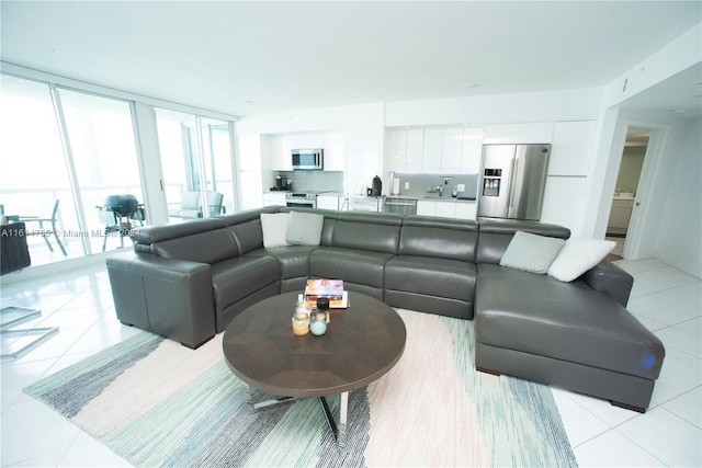 tiled living room featuring a wall of windows