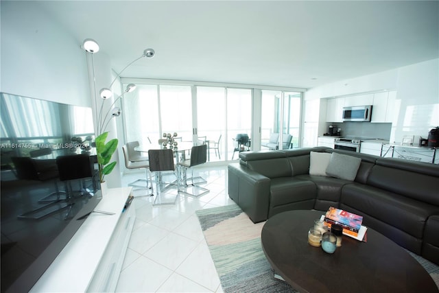 living room featuring a wall of windows, plenty of natural light, and light tile patterned floors