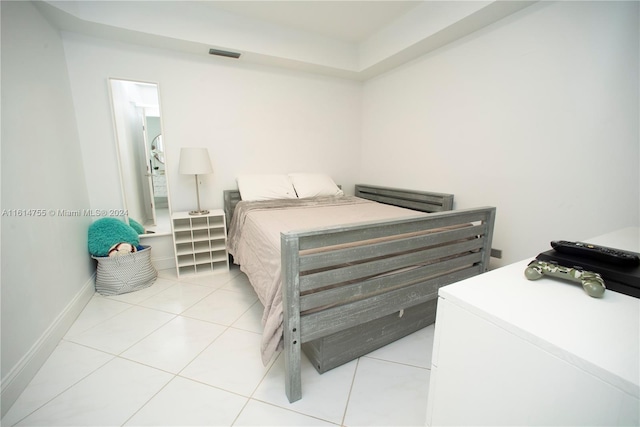 bedroom featuring light tile patterned flooring